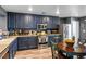 Stylish eat-in kitchen with stainless appliances and rich blue cabinetry at 8884 Perfect Diamond Ct, Las Vegas, NV 89129