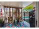 Relaxing covered patio offers seating and a mini-fridge with views of the pool at 8884 Perfect Diamond Ct, Las Vegas, NV 89129