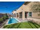 Scenic backyard with a modern pool, lush landscaping, and a covered patio area at 9588 Archer Peak Ct, Las Vegas, NV 89143