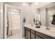 Modern bathroom featuring double sinks, contemporary finishes, and an adjacent shower/tub at 9588 Archer Peak Ct, Las Vegas, NV 89143