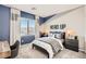 Stylish bedroom featuring a 'HERO UP' theme, complemented by a desk and a view at 9588 Archer Peak Ct, Las Vegas, NV 89143
