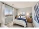 Inviting bedroom with a serene view, featuring soft blue tones and ample natural light at 9588 Archer Peak Ct, Las Vegas, NV 89143