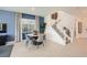 Bright dining area with modern table, chairs, and large windows at 9588 Archer Peak Ct, Las Vegas, NV 89143