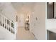 Bright foyer with white walls, tiled floor, stairs, and a console table at 9588 Archer Peak Ct, Las Vegas, NV 89143