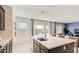 Modern kitchen island featuring a stainless steel sink, and a view into the living room at 9588 Archer Peak Ct, Las Vegas, NV 89143