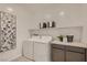 Functional laundry room offers counter space, modern washer and dryer, and decor at 9588 Archer Peak Ct, Las Vegas, NV 89143