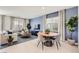 Comfortable living space features a dining table, plush sofa, and natural light at 9588 Archer Peak Ct, Las Vegas, NV 89143