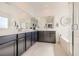 Bright main bathroom features a dual sink vanity, a soaking tub, and walk-in glass shower at 9588 Archer Peak Ct, Las Vegas, NV 89143