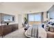 Well-lit main bedroom features an accent wall, a patio, and calming neutral tones at 9588 Archer Peak Ct, Las Vegas, NV 89143