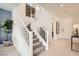 Bright staircase with white railings and carpeted steps at 9588 Archer Peak Ct, Las Vegas, NV 89143