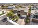 Aerial view of a two-story home with lush landscaping and a brick driveway at 9655 Skye Star Ave, Las Vegas, NV 89166