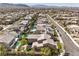 Aerial view of a neighborhood featuring homes with pools, well-maintained streets, and lush greenery at 9655 Skye Star Ave, Las Vegas, NV 89166