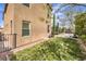 A serene backyard with lush green grass, stone landscaping, and a shaded patio area for outdoor relaxation at 9655 Skye Star Ave, Las Vegas, NV 89166