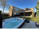 A large two story home with a backyard featuring a hot tub on a wooden deck at 9655 Skye Star Ave, Las Vegas, NV 89166