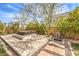 Backyard featuring a deck with a hot tub, water feature, and mature trees at 9655 Skye Star Ave, Las Vegas, NV 89166