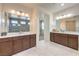 Dual vanity bathroom with modern lighting, tile floors, and generous counter space at 9655 Skye Star Ave, Las Vegas, NV 89166