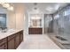 Contemporary bathroom with double sinks, a glass-enclosed shower, and tiled floors at 9655 Skye Star Ave, Las Vegas, NV 89166