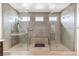 Spa-like bathroom featuring dual showers, tiled walls, and neutral color palette at 9655 Skye Star Ave, Las Vegas, NV 89166