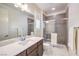 Modern bathroom featuring a glass-enclosed shower, sleek vanity, and neutral color palette at 9655 Skye Star Ave, Las Vegas, NV 89166