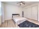 Minimalist bedroom with a sliding door closet, neutral tones, and natural light at 9655 Skye Star Ave, Las Vegas, NV 89166