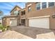 Exterior elevation showing the brick paver driveway and three car garage on a sunny day at 9655 Skye Star Ave, Las Vegas, NV 89166