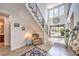Bright foyer featuring a modern staircase, high ceilings, and views of the backyard at 9655 Skye Star Ave, Las Vegas, NV 89166