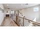 Bright hallway with hardwood floors, modern railings, and an abundance of natural light at 9655 Skye Star Ave, Las Vegas, NV 89166