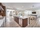Open-concept kitchen with a large island, stainless steel appliances, and seamless flow to the dining area at 9655 Skye Star Ave, Las Vegas, NV 89166