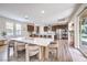 Open-concept kitchen and dining area with stainless steel appliances and bar seating at a large island at 9655 Skye Star Ave, Las Vegas, NV 89166