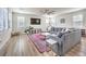 Bright living room with a large sectional sofa, hardwood floors, and modern decor at 9655 Skye Star Ave, Las Vegas, NV 89166