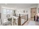 Second floor loft area with modern railing, large clock feature, and plenty of natural light at 9655 Skye Star Ave, Las Vegas, NV 89166