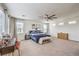 Spacious main bedroom with large windows, ceiling fan, and neutral carpeting at 9655 Skye Star Ave, Las Vegas, NV 89166