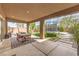 Covered patio featuring an outdoor dining area, trampoline, and landscaped backyard at 9655 Skye Star Ave, Las Vegas, NV 89166