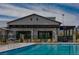 Community pool area featuring a large pool, patio furniture, and a community center at 9655 Skye Star Ave, Las Vegas, NV 89166