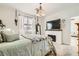 Bedroom with a comfortable bed, fireplace, and a mounted TV at 9698 Pacific Pine St, Las Vegas, NV 89143