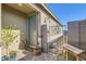 Inviting front entrance with a charming blue door, potted plants, and a decorative welcome gate at 9698 Pacific Pine St, Las Vegas, NV 89143