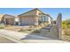 Charming home featuring a brick driveway, two-car garage, and desert landscaping at 9698 Pacific Pine St, Las Vegas, NV 89143