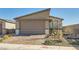 Exterior elevation showcasing a well-maintained home with a brick driveway and low-maintenance landscaping at 9698 Pacific Pine St, Las Vegas, NV 89143