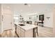 Bright kitchen features an island with white countertops and stainless steel dishwasher at 9698 Pacific Pine St, Las Vegas, NV 89143
