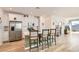 Modern kitchen with stainless steel appliances, island with bar stools, and hardwood floors at 9698 Pacific Pine St, Las Vegas, NV 89143