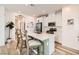 Stylish kitchen featuring an island with bar stools, white cabinetry, and stainless steel appliances at 9698 Pacific Pine St, Las Vegas, NV 89143