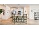 Modern kitchen with white cabinets, stainless steel appliances, and an island with bar seating at 9698 Pacific Pine St, Las Vegas, NV 89143