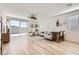 Open-concept living room featuring hardwood floors, modern decor, and sliding glass doors at 9698 Pacific Pine St, Las Vegas, NV 89143