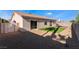 Well maintained backyard featuring a brick patio, desert landscaping, and vibrant green turf at 9705 Standard Ave, Las Vegas, NV 89129