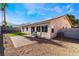 Landscaped backyard featuring a brick patio, desert landscaping, and vibrant green turf at 9705 Standard Ave, Las Vegas, NV 89129