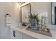 Stylish bathroom with a sleek vanity, modern fixtures, and decorative accents at 9705 Standard Ave, Las Vegas, NV 89129