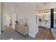 Spacious primary bedroom with a dresser which leads into a spa-like bathroom with marble tiling and glass shower at 9705 Standard Ave, Las Vegas, NV 89129