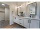Elegant bathroom with double vanities, modern lighting, and a walk-in closet at 9705 Standard Ave, Las Vegas, NV 89129