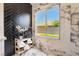 Elegant bathroom showcasing marble walls, a large window, and a modern design at 9705 Standard Ave, Las Vegas, NV 89129