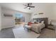 Cozy bedroom featuring a king-size bed, soft carpet, and a sliding door to the backyard at 9705 Standard Ave, Las Vegas, NV 89129